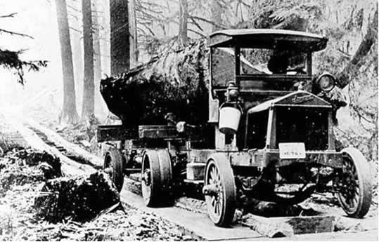 Figure 1.1. Early truck hauling split spruce log on a “fore and aft” plank road on the Olympic Peninsula (Forks Timber Museum).